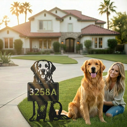 Golden Retriever sitting next to personalized metal address garden stake in front of family home