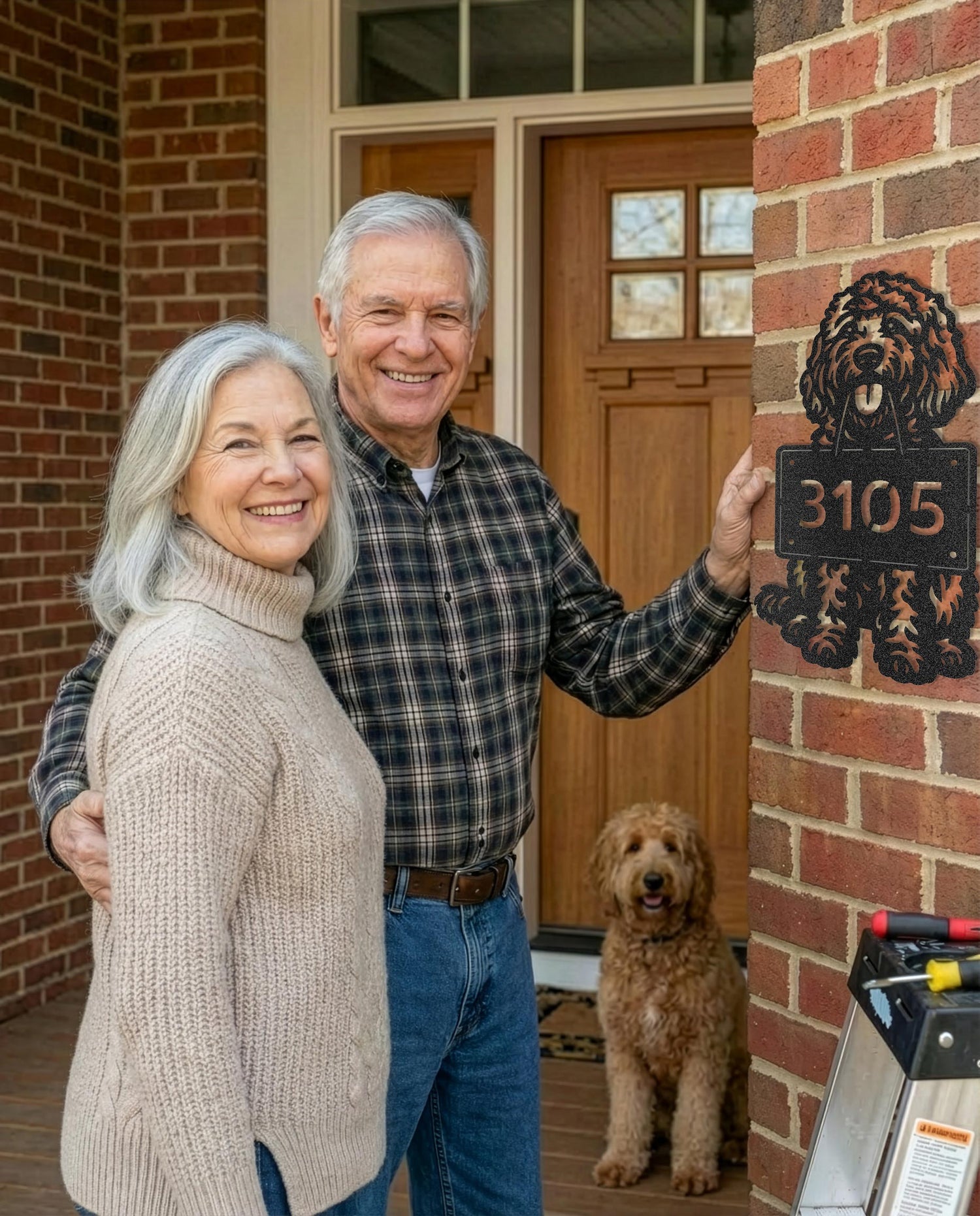 Happy couple installing a custom metal dog address sign beside their front door – Prime Steel Studio satisfaction guarantee